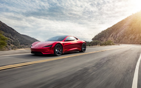 Red Tesla Roadster car driving on the highway