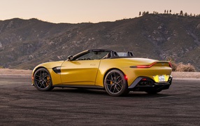 Yellow 2021 Aston Martin Vantage Roadster against mountains