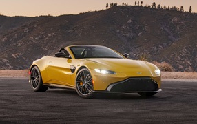 Yellow 2021 Aston Martin Vantage Roadster against the hills