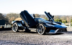 Black Ford GT sports car with open doors