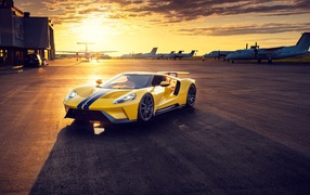 Yellow Ford GT sports car at sunset