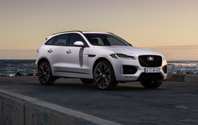 White off-road Jaguar F-Pace 25d AWD Checkered Flag 2020 near the water