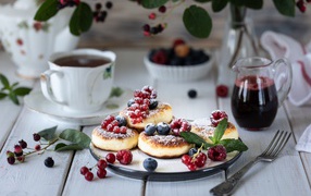 Cheesecakes on a table with berries and tea for breakfast