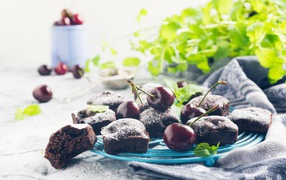 Chocolate muffins on a plate with cherries
