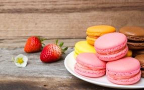 Colorful macaroon dessert on a table with strawberries