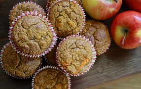 Fresh muffins on the table with apples