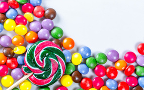 Multicolored candies in glaze and caramel on a white background