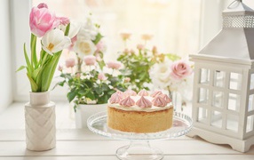 Tasty pie on the table with a bouquet of tulips