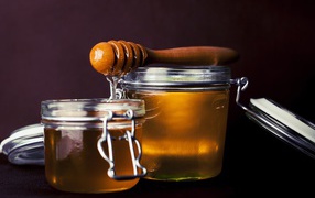 Two glass jars with honey