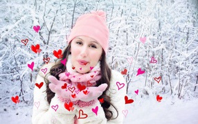 Beautiful girl sends air kisses in winter