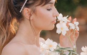 Beautiful girl with white flowers in her hand