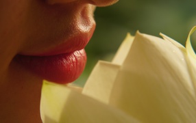 Beautiful lips of a girl with a flower