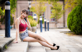 Cute smiling asian girl sitting on the steps