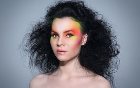 Girl with fleece on her hair with bright makeup on a gray background