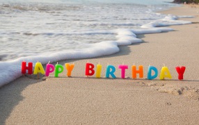Happy Birthday Candles on Sea Sand