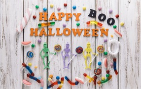 Sweets and decorations on a wooden background for Halloween
