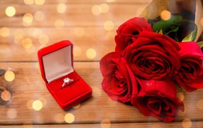 Beautiful bouquet of red roses with a diamond ring as a gift for your beloved on March 8