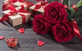 Three red roses and gifts for International Women's Day March 8