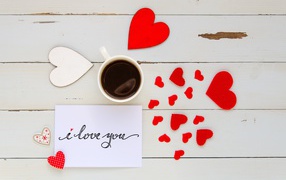 Hearts and a cup of coffee on the table for the beloved on February 14