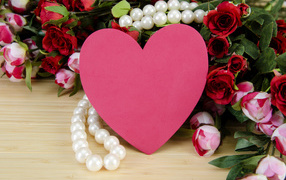 Pink heart, a bouquet of roses and pearl beads for a beloved on Valentine's Day
