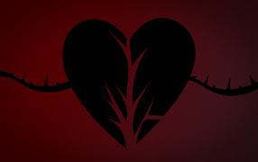 Black torn heart on a red background