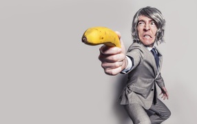Man in a suit defends himself with a banana