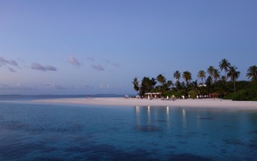 Calm blue ocean water on a tropical beach at dusk