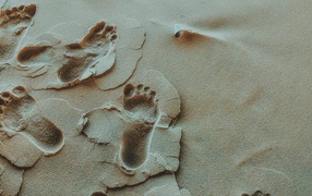 Human footprints in the sand close up