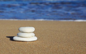 Round white stones on yellow sand