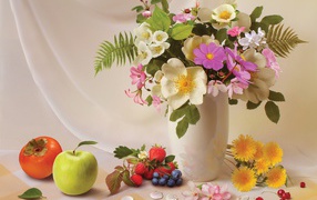 Bouquet in a vase on a table with fruits and berries