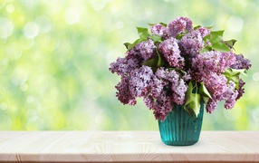 Bouquet of fragrant lilacs in a vase on the table