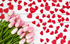Bouquet of pink tulips on a white background with red hearts