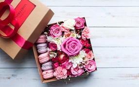 Box with fresh flowers and dessert for a gift