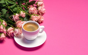 Cup of coffee and a bouquet of beautiful roses on a pink background