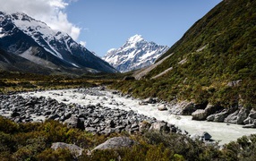Заледеневшая река на фоне заснеженных гор 