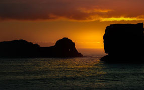 Cliffs in the sea at sunset