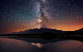Snow-capped volcano peak under the starry sky