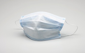 Medical mask protection against coronavirus covid-19 on a gray background