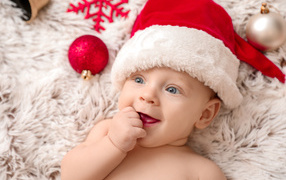 Cute baby in red santa claus hat