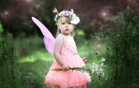 Little cute girl in a pink fairy dress
