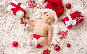 Smiling child in red hat with gifts