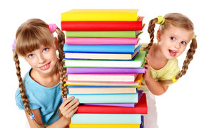 Two little girls with colorful books on a white background