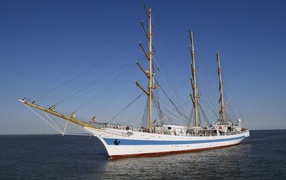 Large ship with lowered sails at sea