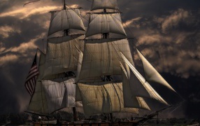 More ship with white sails against the sky at dusk