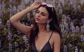Actress Victoria Justice on a field with flowers