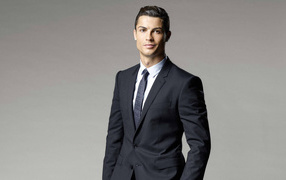 Soccer player Cristiano Ronaldo in a suit on a gray background