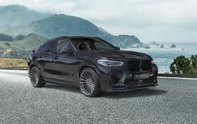 Черный автомобиль Hamann BMW X6 M Competition 2021 года на фоне гор