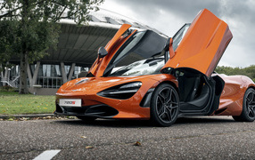 Оранжевый автомобиль McLaren 720S 2021 года с открытыми дверями