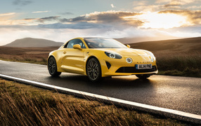 Yellow 2021 Alpine A110 car against sunset