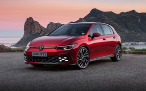 Red Volkswagen Golf GTI 2021 against the backdrop of mountains